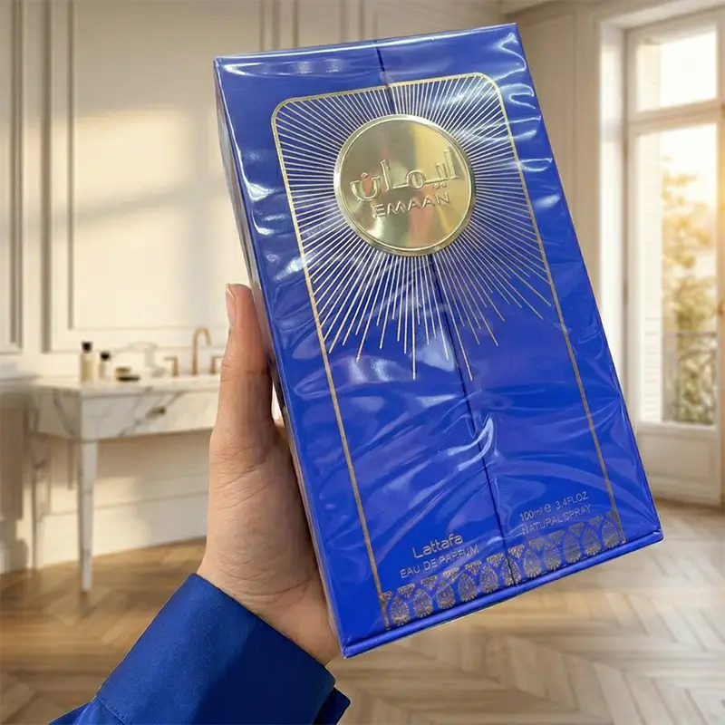 Front view of Lattafa Emaan 100ml EDP women's perfume retail box with premium gold sunburst design.