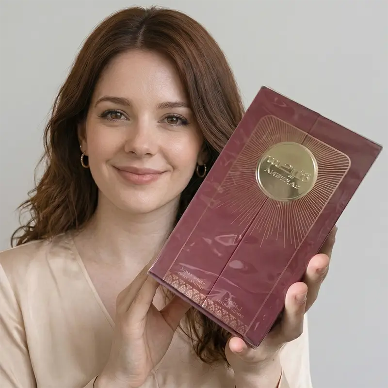 Lifestyle shot of a model holding a factory-sealed Lattafa Sakeena EDP box for unboxing presentation.